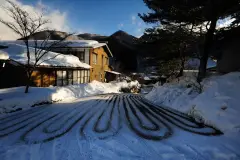 Snow-covered street and buildings in Fukuchi Onsen